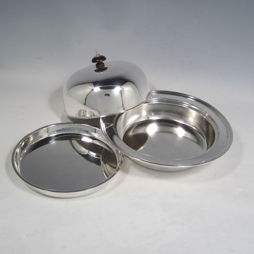 Sterling silver muffin dish, having a plain round body, with lift-off lid and wooden finial, an interior lift-out liner, and sitting on a flat base. Made by the Adie Brothers of Birmingham in 1939. The dimensions of this fine hand-made silver muffin dish are diameter 18 cms (7 inches), height 10 cms (4 inches), and it weighs approx. 480g (15.5 troy ounces).