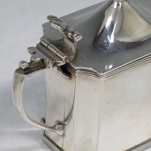 An Antique Edwardian Sterling Silver mustard pot, having a plain straight-sided body with cut-corners and applied reeded borders, a hinged domed lid with cast scroll thumb-piece and urn finial, a plain scroll handle, an original blue-glass liner, and sitting on a flat base. Made by Zachariah Barraclough & Sons of Chester in 1907. The dimensions of this fine hand-made antique silver mustard pot are length 9 cms (3.5 inches), height 9 cms (3.5 inches), and it weighs approx. 136g (4.4 troy ounces).    