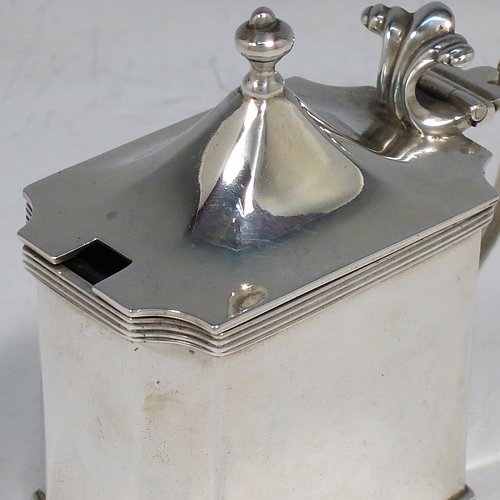 An Antique Edwardian Sterling Silver mustard pot, having a plain straight-sided body with cut-corners and applied reeded borders, a hinged domed lid with cast scroll thumb-piece and urn finial, a plain scroll handle, an original blue-glass liner, and sitting on a flat base. Made by Zachariah Barraclough & Sons of Chester in 1907. The dimensions of this fine hand-made antique silver mustard pot are length 9 cms (3.5 inches), height 9 cms (3.5 inches), and it weighs approx. 136g (4.4 troy ounces).    