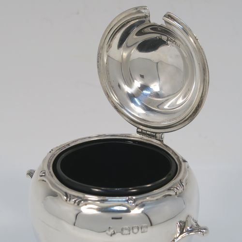 An unusual and rare Antique Edwardian Art Nouveau mustard pot, having a plain round bellied body with two cast scroll side-handles, an applied scroll style top border, a hinged lid with a cast urn finial, an internal blue glass liner, and all sitting on a flat base. This beautiful silver mustard pot comes with a garden shovel style silver spoon. This elegant silver Art Nouveau mustard pot was made by Jackson and Fullerton of London in 1909. The dimensions of this fine hand-made antique silver mustard pot are height 10 cms (4 inches), diameter 7 cms (2.75 inches), and it weighs approx. 114g (3.7 troy ounces).  