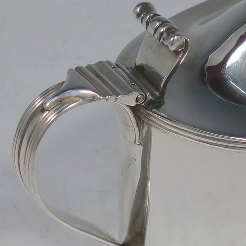 An Antique Georgian Sterling Silver mustard pot, having a plain oval straight-sided body, with applied reeded borders, a hinged domed lid with cast thumb-pieced and finial, a reeded scroll handle, a blue-glass liner, and sitting on a flat base. Made by Frances Purton & Thomas Johnson of London in 1794. The dimensions of this fine hand-made antique silver mustard pot are length 11 cms (4.25 inches), height 8.5 cms (3.3 inches), and it weighs approx. 125g (4 troy ounces).