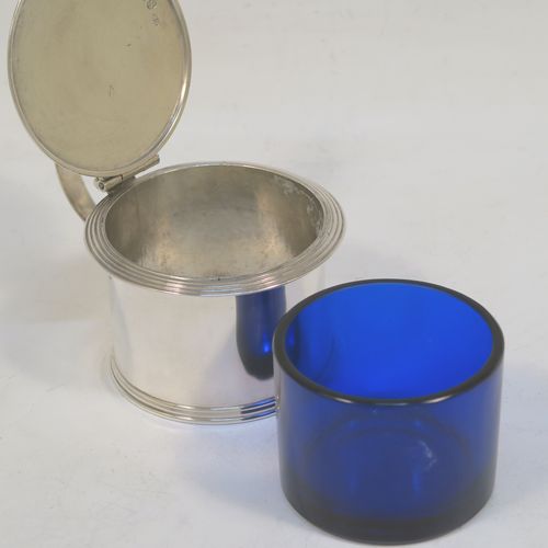 A very elegant Antique Georgian Sterling Silver drum mustard, having a plain cylindrical body, with applied reeded borders, a hinged flat lid with a cast shell thumb-piece, a scroll handle and a blue glass liner. Made by Charles Fox of London in 1833. The dimensions of this fine hand-made antique silver mustard pot are height 6 cms (2.3 inches), diameter 6.5 cms (2.5 inches), and it weighs approx. 90g (3 troy ounces).  