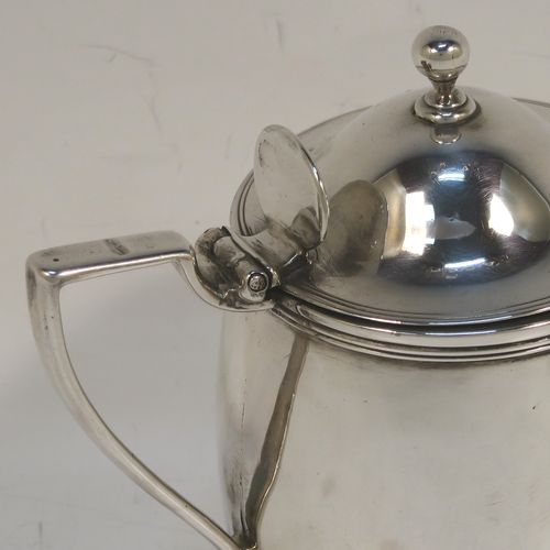 A rare and very elegant Antique Georgian Sterling Silver pair of drum mustard pots, having plain round bodies with slightly convex sides, with applied reeded top and bottom borders, domed hinged lids with plain oval thumb-pieces and ball finials, scroll side-handles, and a blue-glass and clear glass liner. These beautiful silver mustard pots were made by John Emes of London in 1802. The dimensions of these fine hand-made antique silver mustard pots are length 8.5 cms (3.3 inches), height 8.5 cms (3.3 inches), diameter of bodies 6 cms (2.25 inches), and they weigh a total of approx. 213g (6.9 troy ounces).  