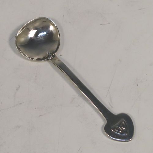 A very unusual Antique Edwardian Arts and Crafts style mustard pot and spoon, having a plain round bellied body, with a hinged lid, a tendril style side-handle, sitting on four ball feet, and with an internal blue glass liner, together with its original condiment spoon. This elegant antique silver mustard pot was made by James Fenton and Co., of Birmingham in 1906. The dimensions of these fine hand-made antique Art and Crafts silver mustard pot are height 5 cms (2 inches), diameter 6 cms (2.3 inches), and it weighs approx. 78g (2.5 troy ounces).   