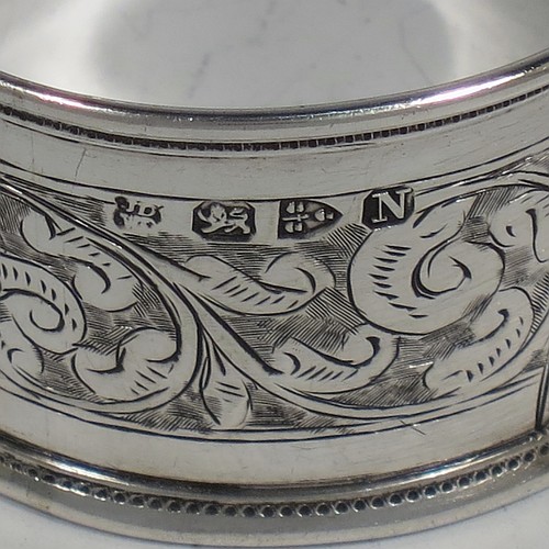 A very pretty Antique Victorian Sterling Silver pair of napkin rings, having round straight-sided bodies with applied borders, each one hand-engraved with a band of floral and scroll-work decoration, with shield-shaped vacant cartouches, and all in their original maroon satin and velvet-lined presentation box. Made by the Deakin Brothers of Chester in 1896. The dimensions of these fine hand-made antique silver napkin rings are diameter 4.5 cms (1.75 inches), height 2.5 cms (1 inch), and they weigh a total of approx. 36g (1.2 troy ounces).    