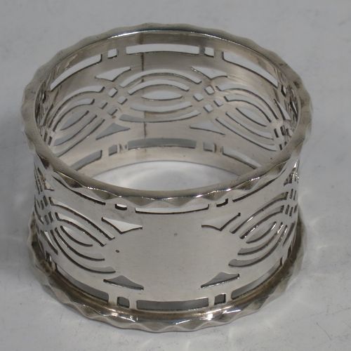 A pretty Antique Sterling Silver set of six napkin rings, having round straight-sided bodies, with hand-pierced geometrical style decoration, a central oval vacant cartouche, and with applied faceted borders, all in their original maroon satin and velvet-lined presentation box. Made by Ferganbaum and Son of Birmingham in 1921. The dimensions of these fine hand-made silver napkin rings are diameter 4.5 cms (1.75 inches), height 2.5 cms (1 inch), and they weigh a total of approx. 140g (4.5 troy ounces). 