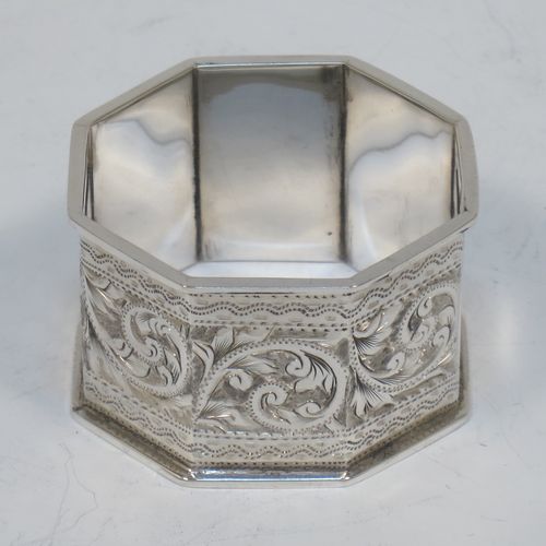 A very pretty Antique Victorian Sterling Silver set of six napkin rings, having octagonal panelled and straight-sided bodies, with hand-engraved floral and scroll decoration, with one panel as a vacant cartouche, and all in their original dark blue  satin and velvet-lined presentation box. Made by the Rolason Brothers of Birmingham in 1897. The dimensions of these fine hand-made antique silver napkin rings are width 4.5 cms (1.75 inches), height 2.5 cms (1 inch), and they weigh a total of approx. 115g (3.7 troy ounces).   