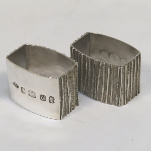 A very unusual Modernistic style Sterling Silver pair of napkin rings, having straight sided rectangular bodies with three sides having a cast bark-like finish, and the fourth side with large spread hallmarks including the Queens Jubilee mark. These beautiful silver napkin rings were made by Graham Watling of London in 1977. The dimensions of these fine hand-made silver napkin rings are length 4.5 cms (1.75 inches), height 3 cms (1.25 inches), and they weigh a total of approx. 93g (3 troy ounces).   