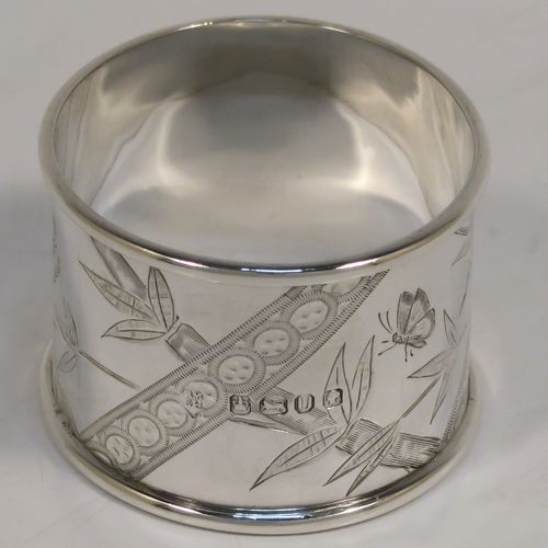 A very pretty Antique Victorian Sterling Silver pair of napkin rings, in an Aesthetic style having round straight-sided bodies with hand-engraved bamboo and butterfly decoration, and all in their original maroon satin and velvet-lined presentation box. These beautiful antique silver Aesthetic style napkin rings were made by Martin Hall and Co., of Sheffield in 1887. The dimensions of these fine hand-made antique silver napkin rings are diameter 4 cms (1.5 inches), height 3 cms (1 inch), and they weigh a total of approx. 34g (1 troy ounce).   