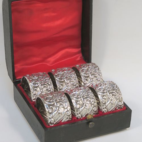 A very pretty Antique Victorian Sterling Silver set of six napkin rings, having round straight-sided bodies, with hand-chased floral, scroll and fluted decoration, and all in their original red satin and velvet-lined presentation box. These beautiful silver napkin rings were made by Henry Matthews of Birmingham in 1901. The dimensions of these fine hand-made antique silver napkin rings are diameter 4.5 cms (1.75 inches), height 2.5 cms (1 inch), and they weigh a total of approx. 120g (3.9 troy ounces).  