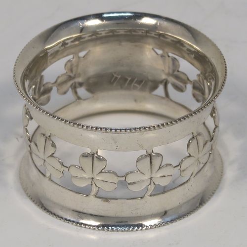 A pretty Antique Edwardian Sterling Silver set of six napkin rings, having round straight-sided bodies, with hand-pierced three-leaf clover Shamrock style decoration, and with bead borders, all in their original dark-blue satin and velvet-lined presentation box. These beautiful silver napkin rings were made by Charles Horner of Birmingham in 1902. The dimensions of these fine hand-made silver napkin rings are diameter 4.5 cms (1.75 inches), height 2.5 cms (1 inch), and they weigh a total of approx. 95g (3.6 troy ounces).   