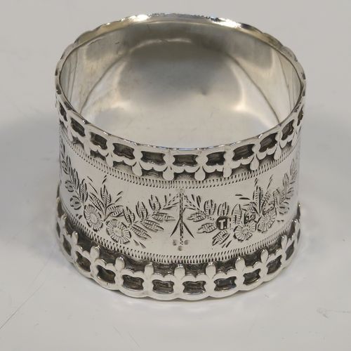 A very unusual Antique Edwardian Sterling Silver pair of napkin rings, having straight sided round bodies with applied fleur-de-lis borders, and hand-engraved floral decoration surrounding a vacant cartouche. These beautiful silver napkin rings were made by Thomas Hayes of Birmingham in 1906. The dimensions of these fine hand-made silver napkin rings are diameter 4.5 cms (1.75 inches), height 3.5 cms (1.3 inches), and they weigh a total of approx. 62g (2 troy ounces).  