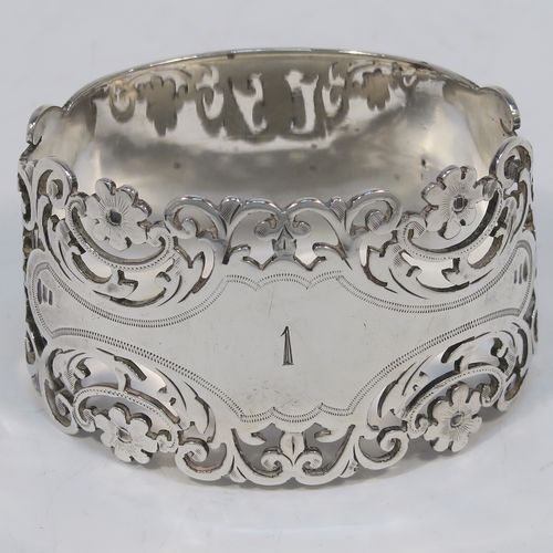 A very pretty and heavy Antique Victorian Sterling Silver pair of napkin rings, having oval straight-sided bodies with hand-pierced and engraved floral and scroll decoration, all in their original cream  satin and dark blue velvet-lined presentation box. These beautiful antique silver napkin rings were made by Alexander Clarke of Sheffield in 1901. The dimensions of these fine hand-made antique silver napkin rings are length 6 cms (2.25 inches), height 3.5 cms (1.3 inches), and they weigh a total of approx. 93g (3 troy ounces). Please note that these napkin rings are numbered one and two. 