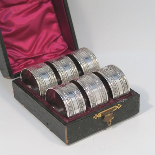 A very pretty Antique Victorian Silver-Plated set of six napkin rings, having round straight-sided bodies, with hand-engraved floral band decoration, and all in their original maroon satin and velvet-lined presentation box. This beautiful set of silver-plated napkin rings were made in ca. 1880. The dimensions of these fine hand-made antique silver plated napkin rings are diameter 4 cms (1.5 inches), and height 2 cms (0.75 inch). Please note that they are numbered with hand-engraved one to six.