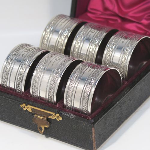 A very pretty Antique Victorian Silver-Plated set of six napkin rings, having round straight-sided bodies, with hand-engraved floral band decoration, and all in their original maroon satin and velvet-lined presentation box. This beautiful set of silver-plated napkin rings were made in ca. 1880. The dimensions of these fine hand-made antique silver plated napkin rings are diameter 4 cms (1.5 inches), and height 2 cms (0.75 inch). Please note that they are numbered with hand-engraved one to six.