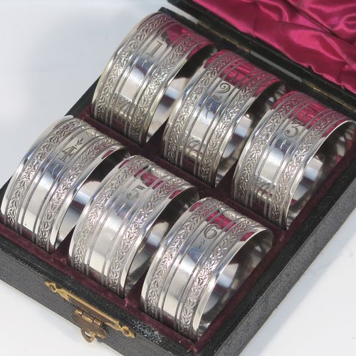 A very pretty Antique Victorian Silver-Plated set of six napkin rings, having round straight-sided bodies, with hand-engraved floral band decoration, and all in their original maroon satin and velvet-lined presentation box. This beautiful set of silver-plated napkin rings were made in ca. 1880. The dimensions of these fine hand-made antique silver plated napkin rings are diameter 4 cms (1.5 inches), and height 2 cms (0.75 inch). Please note that they are numbered with hand-engraved one to six.