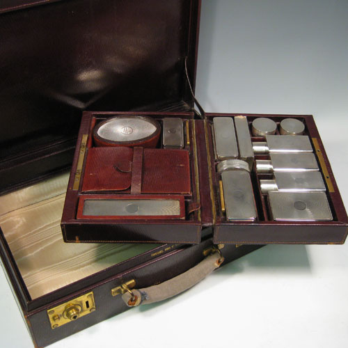 Sterling silver necessaire in original leather travel case. Having a hair brush, clothes brush, easel mirror, six boxes of various shapes and sizes, a toothbrush holder, a glass lined inkwell box, three cologne bottles, and a leather bound manicure set (some items missing from this). All made by Goldsmiths and Silversmiths of London in 1929.