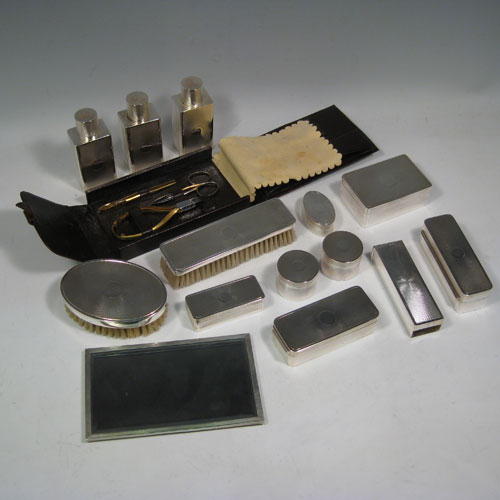 Sterling silver necessaire in original leather travel case. Having a hair brush, clothes brush, easel mirror, six boxes of various shapes and sizes, a toothbrush holder, a glass lined inkwell box, three cologne bottles, and a leather bound manicure set (some items missing from this). All made by Goldsmiths and Silversmiths of London in 1929.