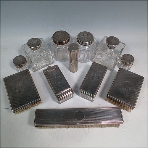 An Antique Victorian Sterling Silver travelling Necessaire, having two cologne bottles, two large bottles, two small bottles, a hair brush, two clothes brushes, an inkwell, a shaving brush, a soap box, a folding desk mirror, and internal space for letters, pens, and jewellery, all fitted in an original maroon velvet-lined oak box with brass fittings. All silver items have engine-turned decoration with central cartouches that are crested, and are made by Thomas Johnson of London in 1862. The dimensions of the solid oak box are 30.5 cms (12 inches), height 14 cms (5.5 inches), and width 24 cms (9.5 inches). Please note that the box is slightly damaged, but otherwise in excellent condition. All silver and crystal items are original with full matching hallmarks.