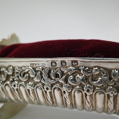 An Antique Victorian Sterling Silver pin cushion, in the form of a babies rocking crib, with hand-chased floral and fluted decoration, together with a maroon velvet covered cushion. Made by Saunders and Shepherd of Birmingham in 1896. The dimensions of this fine hand-made antique silver pin cushion are length 6 cms (2.3 inches), width 3.5 cms (1.3 inches), height 4 cms (1.5 inches), and it weighs approx. 33g (1 troy ounces).   