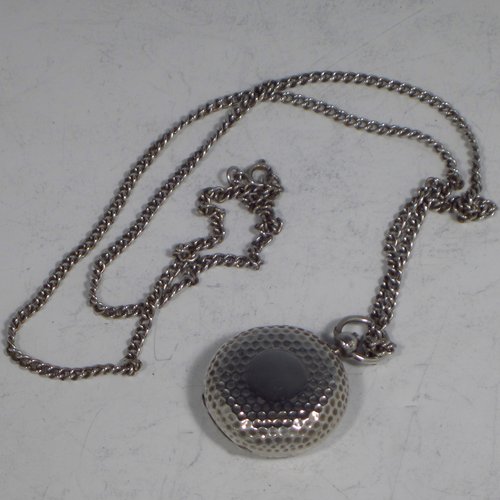 An Antique Edwardian Sterling silver single Sovereign case and original chain, having a round body with hand-hammered decoration and in the shape of a Hunter fob watch, with hinged lid, internal sprung mechanism which is in working order, and push-button clasp, all made by Alexander Davenport of Birmingham in 1908. The dimensions of this fine hand-made silver sovereign case are length 4 cms (1.5 inches), and it weighs a total of 39g (1.25 troy ounces).   