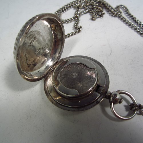 An Antique Edwardian Sterling silver single Sovereign case and original chain, having a round body with hand-hammered decoration and in the shape of a Hunter fob watch, with hinged lid, internal sprung mechanism which is in working order, and push-button clasp, all made by Alexander Davenport of Birmingham in 1908. The dimensions of this fine hand-made silver sovereign case are length 4 cms (1.5 inches), and it weighs a total of 39g (1.25 troy ounces).   