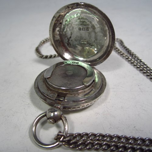 An Antique Edwardian Sterling silver single Sovereign case and original chain, having a round body with hand-hammered decoration and in the shape of a Hunter fob watch, with hinged lid, internal sprung mechanism which is in working order, and push-button clasp, all made by Alexander Davenport of Birmingham in 1908. The dimensions of this fine hand-made silver sovereign case are length 4 cms (1.5 inches), and it weighs a total of 39g (1.25 troy ounces).   