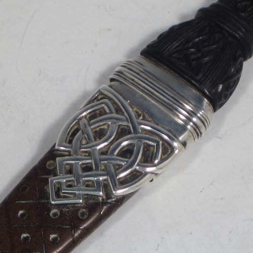 A Scottish Antique Victorian Sterling Silver Sgian Dubh ceremonial knife and scabbard, having a hand-made leather scabbard with Cymric style silver mounts, a black hand-carved Bog-Oak handle with finial and matching decoration, and an original steel blade. Made by James Ross of Edinburgh in 1888. The dimensions of this fine hand-made silver Sgian Dubh are length 23 cms (9 inches), and width 3 cms (1.25 inches).