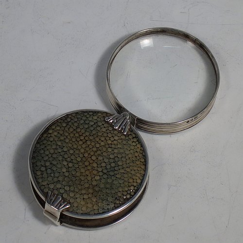 A rare Antique Sterling Silver and Shagreen magnifying glass, having a round body with pull-out and hinged magnifier, with hand-chased reeded borders, and green Shagreen covers. Made by Samuel Jacob of London in 1911. The dimensions of this fine hand-made antique silver and Shagreen magnifying glass and holder are diameter 5 cms (2 inches), length fully unfolded 11 cms (4.3 inches), and depth 1.5 cms (0.5 inch).   