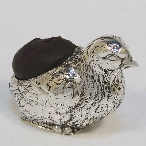 A very pretty and rare Antique Sterling Silver pin cushion, in the form of a hen chick, with hand-chased body and face, and a leather covered cushion. This interesting antique silver pin cushion was made by Sampson and Mordan of Birmingham in 1914. The dimensions of this fine hand-made antique silver pin cushion are length 5 cms (2 inches), width 2.5 cms (1 inch), and height 2.5 cms (1 inch). Please note that the cushions leather covering is slightly damaged.