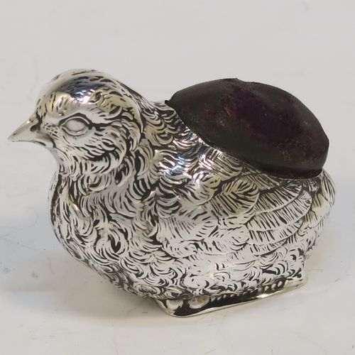 A very pretty and rare Antique Sterling Silver pin cushion, in the form of a hen chick, with hand-chased body and face, and a leather covered cushion. This interesting antique silver pin cushion was made by Sampson and Mordan of Birmingham in 1914. The dimensions of this fine hand-made antique silver pin cushion are length 5 cms (2 inches), width 2.5 cms (1 inch), and height 2.5 cms (1 inch). Please note that the cushions leather covering is slightly damaged.