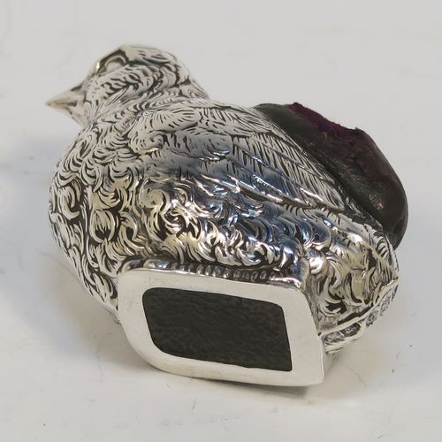 A very pretty and rare Antique Sterling Silver pin cushion, in the form of a hen chick, with hand-chased body and face, and a leather covered cushion. This interesting antique silver pin cushion was made by Sampson and Mordan of Birmingham in 1914. The dimensions of this fine hand-made antique silver pin cushion are length 5 cms (2 inches), width 2.5 cms (1 inch), and height 2.5 cms (1 inch). Please note that the cushions leather covering is slightly damaged.