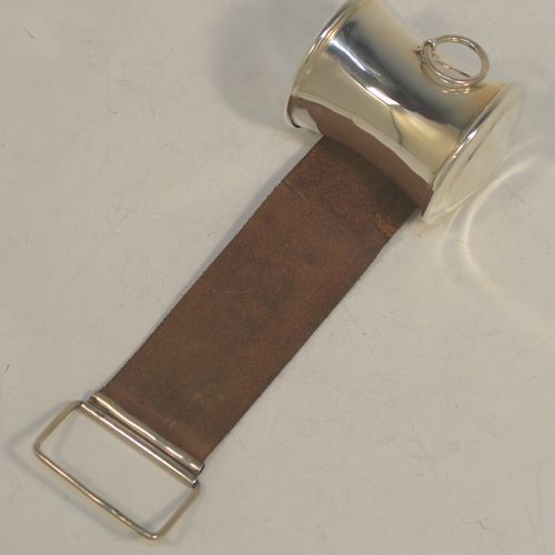 A very handsome and rare Antique Edwardian Sterling Silver and leather shaving cut-throat razor sharpening strop, having a plain cylindrical body with concave sides, a ring carrying handle, and an extendable leather strap with a rectangular hanging loop. Made in Birmingham in 1907. The dimensions of this fine hand-made antique silver and leather cut-throat razor shaving strop are height 32.5 cms (12.75 inches), and diameter at base 11.5 cms (4.5 inches). Please note that the leather strap is slightly damaged with a one cm long cut near the hanging loop.