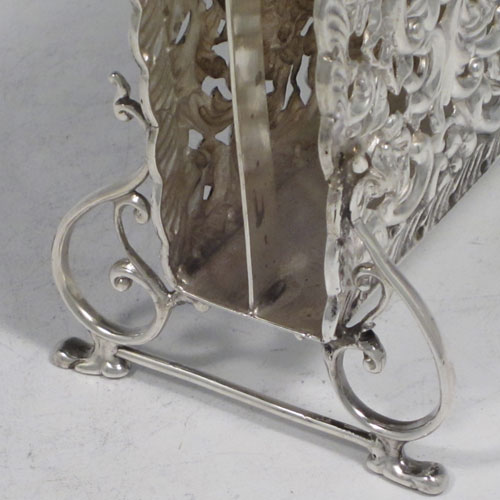 Antique Edwardian rare sterling silver letter rack in the form of a magazine holder, having hand-chased and pierced sides with floral decoration, a central divider with loop handle, and sitting on four scroll feet. Made by Synyer and Beddoes of Birmingham in 1902. The dimensions of this fine hand-made silver letter holder are height 13 cms (5 inches), width 11.5 cms (4.5 inches), depth 7 cms (2.75 inches), and it weighs approx. 168g (5.4 troy ounces).