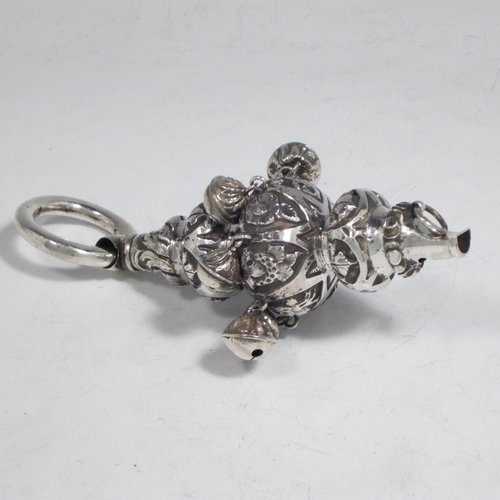 Antique Victorian sterling silver babies rattle, having a round baluster body with hand-chased floral decoration, seven attached bells, a plain round teething ring, and a whistle end. Made in Birmingham in 1870. The dimensions of this fine hand-made silver babies rattle are length 13.5 cms (5.3 inches), width 5 cms (2 inches), and it weighs approx. 67g (2.2 troy ounces).