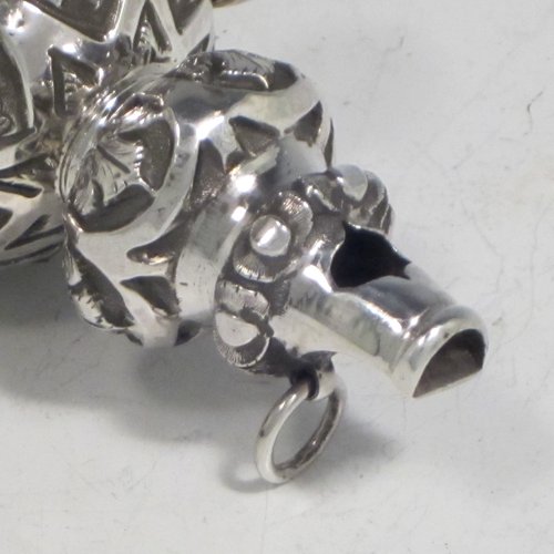 Antique Victorian sterling silver babies rattle, having a round baluster body with hand-chased floral decoration, seven attached bells, a plain round teething ring, and a whistle end. Made in Birmingham in 1870. The dimensions of this fine hand-made silver babies rattle are length 13.5 cms (5.3 inches), width 5 cms (2 inches), and it weighs approx. 67g (2.2 troy ounces).