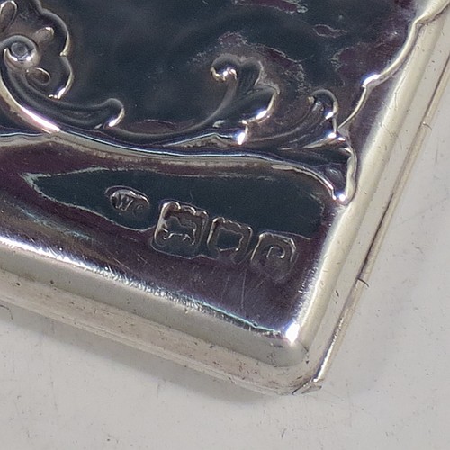 An Antique Victorian Sterling Silver Aide de Memoire and calling card case, having a rectangular body with hand-chased winged cherubs and floral decoration, hinged on one side and with a clasp on the other, and lined with light brown leather pockets. Made by William Comyns of London in 1898. The dimensions of this fine hand-made antique silver Aide de Memoire card case are length 10 cms (4 inches), width 7.5 cms (3 inches), and it weighs approx. 120g (3.9 troy ounces).    