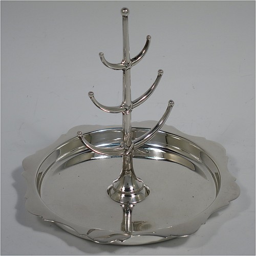 An Antique Sterling Silver ring tree, having a central plain tree for rings attached to a round body with an applied shaped border, and sitting on a flat base. Made by Synter and Beddoes of Birmingham in 1913. The dimensions of this fine hand-made antique silver ring tree are height 10 cms (4 inches), diameter 11 cms (4.25 inches), and it weighs approx. 81g (2.6 troy ounce).    