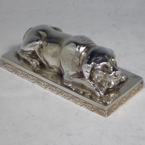 A rare Antique Edwardian Sterling silver table box, in the shape of a dog lying down on all four paws, with a hinged lid, and hand-engraved floral decoration running around the base. Originally made by Berthold Muller of Germany and carrying import marks for London in 1907. The dimensions of this fine hand-made antique silver Dog box are length 10 cms (4 inches), width 4.5 cms (1.75 inches), height 4 cms (1.5 inches), and it weighs approx. 144g (4.6 troy ounces).   