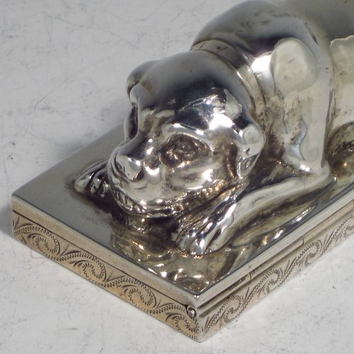 A rare Antique Edwardian Sterling silver table box, in the shape of a dog lying down on all four paws, with a hinged lid, and hand-engraved floral decoration running around the base. Originally made by Berthold Muller of Germany and carrying import marks for London in 1907. The dimensions of this fine hand-made antique silver Dog box are length 10 cms (4 inches), width 4.5 cms (1.75 inches), height 4 cms (1.5 inches), and it weighs approx. 144g (4.6 troy ounces).   