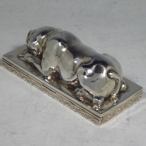 A rare Antique Edwardian Sterling silver table box, in the shape of a dog lying down on all four paws, with a hinged lid, and hand-engraved floral decoration running around the base. Originally made by Berthold Muller of Germany and carrying import marks for London in 1907. The dimensions of this fine hand-made antique silver Dog box are length 10 cms (4 inches), width 4.5 cms (1.75 inches), height 4 cms (1.5 inches), and it weighs approx. 144g (4.6 troy ounces).   