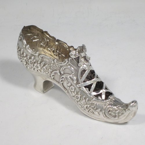 Antique Edwardian sterling silver shoe, having a hand-chased body with floral decoration, with a plain heal, and hand-pierced front laces with a bow. Made by Henry Miller of Birmingham in 1906. The dimensions of this fine hand-made silver shoe are height 5 cms (2 inches), length 11.5 cms (4.5 inches), width 3 cms (1.25 inches), and it weighs approx. 33g (1 troy ounce).   