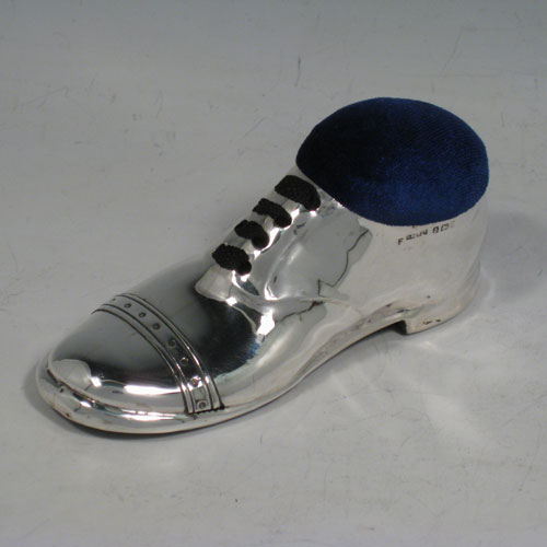 Antique Edwardian sterling silver pin cushion, in the shape of a shoe, having a plain body with laces and an applied decorative band. The dimensions of this fine hand-made silver pin cushion are length 12 cms (4.75 inches), and width 5 cms (2 inches).   