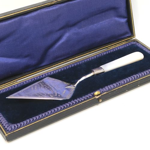 A rare Antique Edwardian Sterling Silver and mother-of-pearl handled ceremonial trowel, the triangular blade having a hand-engraved stone laying inscription for August 15th 1908, in its original dark blue satin and velvet-lined presentation box. This beautiful antique silver trowel was made by Watson and Gillott of Sheffield in 1908. The dimensions of this fine hand-made silver and mother-of-pearl ceremonial trowel length 20cms (8 inches), and width of trowel blade 5.5 cms (2.25 inches).  