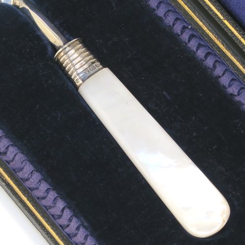 A rare Antique Edwardian Sterling Silver and mother-of-pearl handled ceremonial trowel, the triangular blade having a hand-engraved stone laying inscription for August 15th 1908, in its original dark blue satin and velvet-lined presentation box. This beautiful antique silver trowel was made by Watson and Gillott of Sheffield in 1908. The dimensions of this fine hand-made silver and mother-of-pearl ceremonial trowel length 20cms (8 inches), and width of trowel blade 5.5 cms (2.25 inches).  