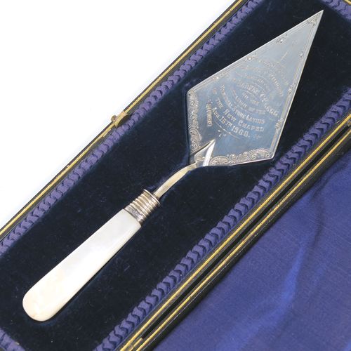 A rare Antique Edwardian Sterling Silver and mother-of-pearl handled ceremonial trowel, the triangular blade having a hand-engraved stone laying inscription for August 15th 1908, in its original dark blue satin and velvet-lined presentation box. This beautiful antique silver trowel was made by Watson and Gillott of Sheffield in 1908. The dimensions of this fine hand-made silver and mother-of-pearl ceremonial trowel length 20cms (8 inches), and width of trowel blade 5.5 cms (2.25 inches).  