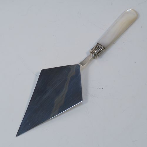 A rare Antique Edwardian Sterling Silver and mother-of-pearl handled ceremonial trowel, the triangular blade having a hand-engraved stone laying inscription for August 15th 1908, in its original dark blue satin and velvet-lined presentation box. This beautiful antique silver trowel was made by Watson and Gillott of Sheffield in 1908. The dimensions of this fine hand-made silver and mother-of-pearl ceremonial trowel length 20cms (8 inches), and width of trowel blade 5.5 cms (2.25 inches).  