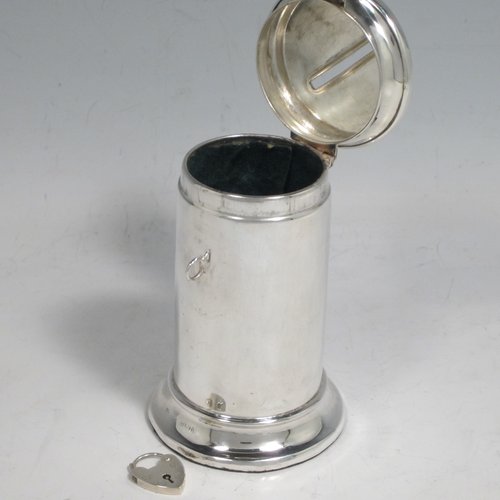 Antique Edwardian sterling silver money box, having a plain round straight-sided body, with hinged money-slot lid, and a hinged clasp with a heart-shaped lock. Made in Birmingham in 1902. The dimensions of this fine hand-made silver money box are height 10 cms (4 inches), diameter at base 6 cms (2.25 inches), and it weighs approx. 95g (3 troy ounces).   