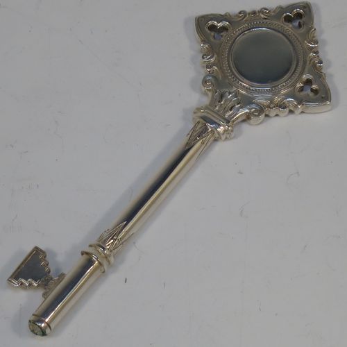 A handsome Sterling Silver 21st key to life, having a cast body with a hand-chased Gothic style handle, a plain shank, hand-chased collars, and a plain key bit, all in its original cream satin and dark-blue velvet-lined presentation box. Made by Vaughton and Sons of Birmingham in 1932. The dimensions of this fine hand-made silver 21st key to life are length 11 cms (4.3 inches) and it weighs approx. 43g (1.4 troy ounces).  