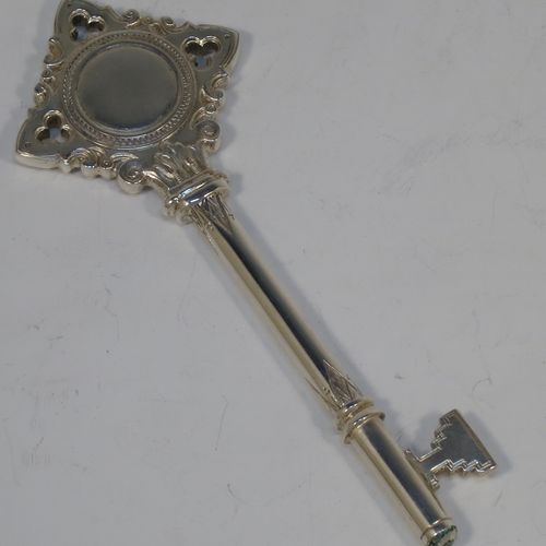 A handsome Sterling Silver 21st key to life, having a cast body with a hand-chased Gothic style handle, a plain shank, hand-chased collars, and a plain key bit, all in its original cream satin and dark-blue velvet-lined presentation box. Made by Vaughton and Sons of Birmingham in 1932. The dimensions of this fine hand-made silver 21st key to life are length 11 cms (4.3 inches) and it weighs approx. 43g (1.4 troy ounces).  